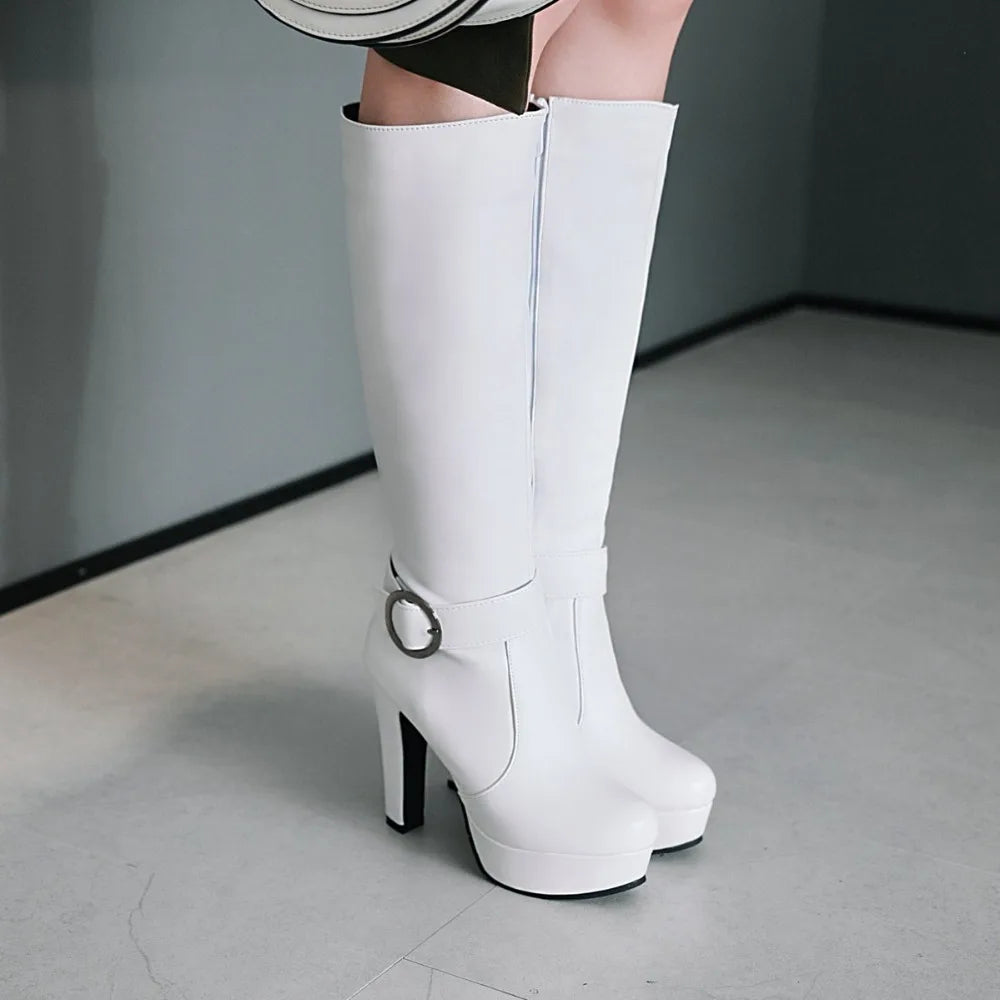 White leather knee-high boots with high heels, platforms, and a buckled strap around the ankle.