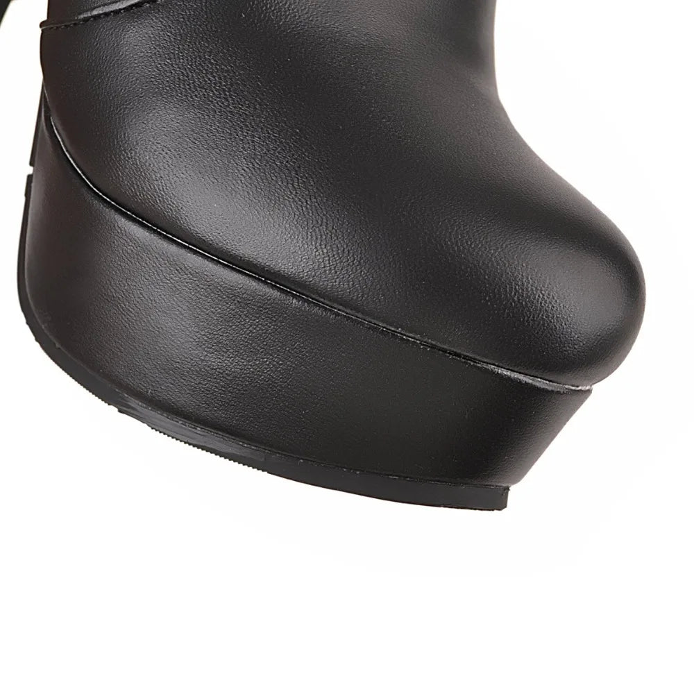 Black faux leather platform boot with a rounded toe.