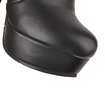 Black faux leather platform boot with a rounded toe.