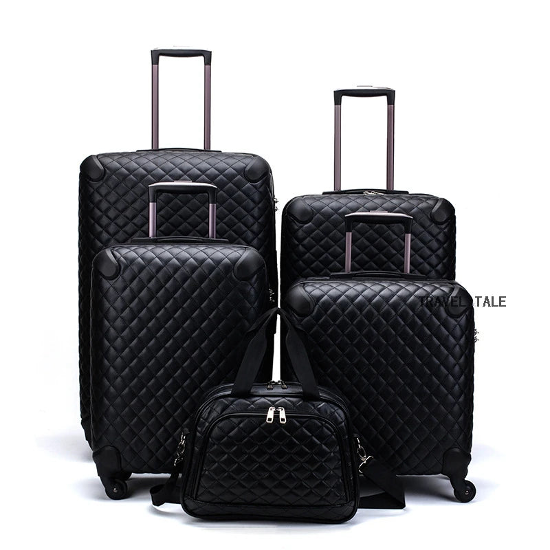 Set of four black quilted leather luggage pieces with spinner wheels and matching handbag.