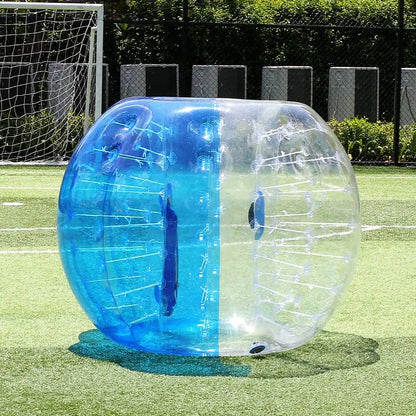 Clear and blue TPU inflatable bumper ball on a grass field for active outdoor sports and family games.
