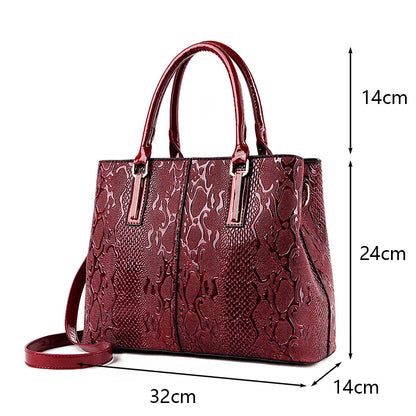 Deep red faux leather shoulder tote with snakeskin texture, zip closure, and adjustable strap for daily carry.