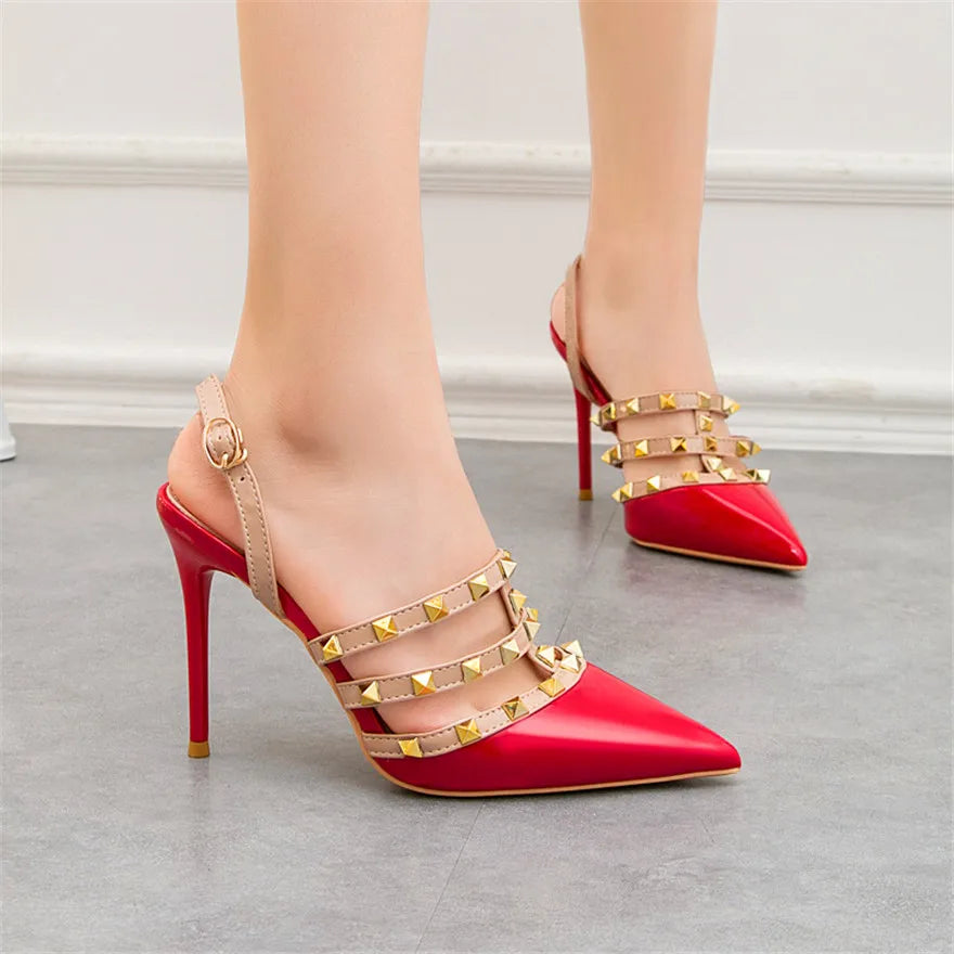 Red patent leather strappy ankle pumps with gold studs for office wear.