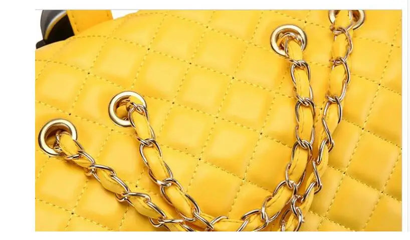Yellow quilted PU leather travel rolling bag with gold chain straps and metal grommets.