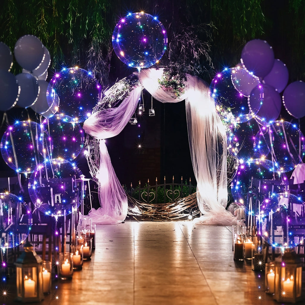 Glowing LED balloons and fairy lights decorate an outdoor wedding archway and pathway at night.