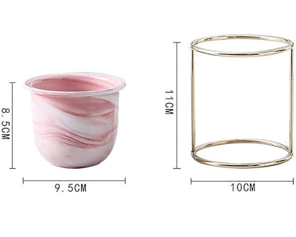 Iron frame ceramic flower pot stand with marble finish; pink marble-pattern planter beside gold metal frame stand