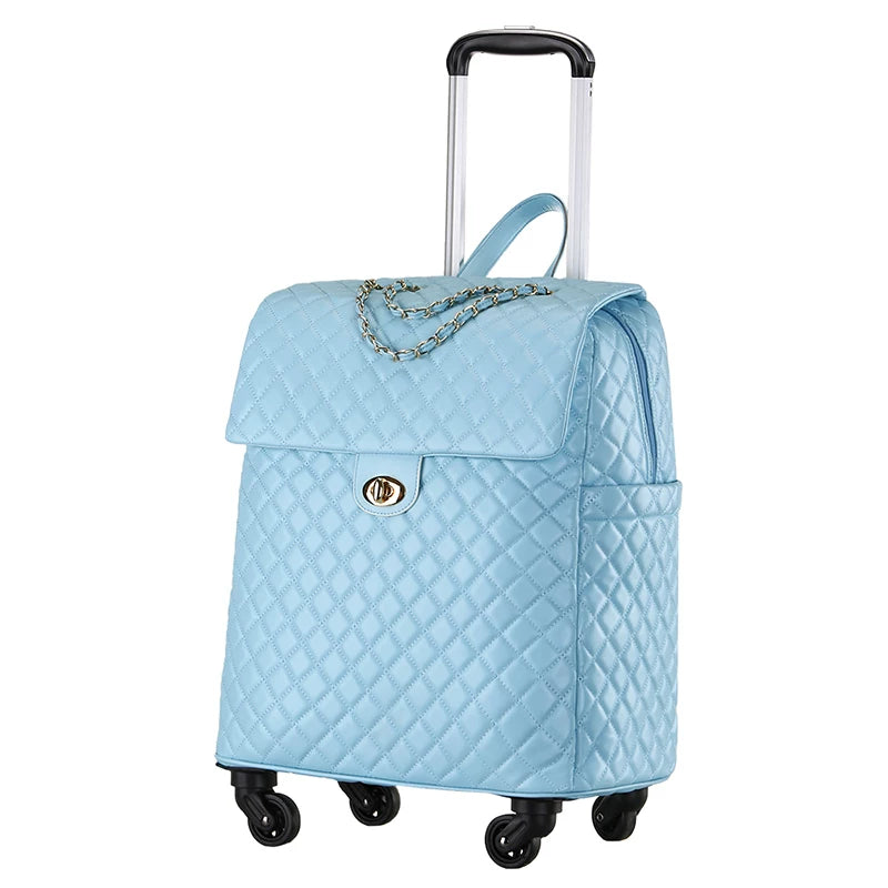 Light blue quilted PU leather rolling luggage with flap top, chain accent, twist lock, and telescoping handle.