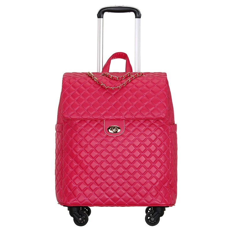 Hot pink quilted PU leather rolling luggage with gold chain detail, turn-lock closure, and a telescoping handle.