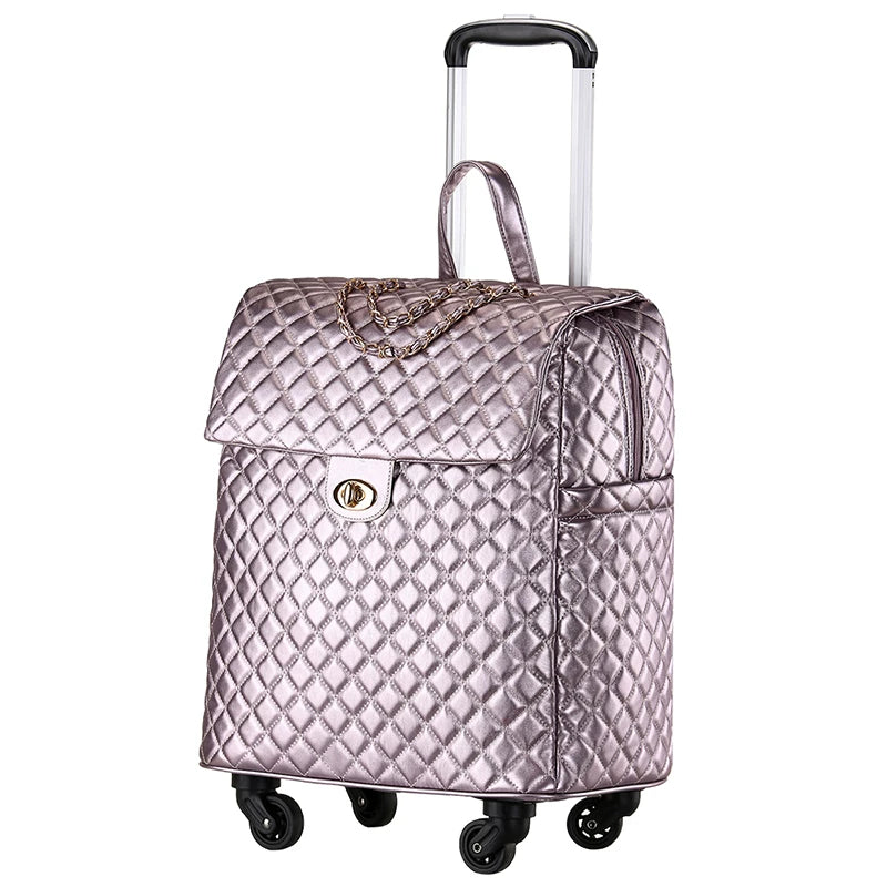Metallic pink quilted PU leather rolling luggage with a chain detail, turn-lock flap, top handle, and extendable trolley handle.