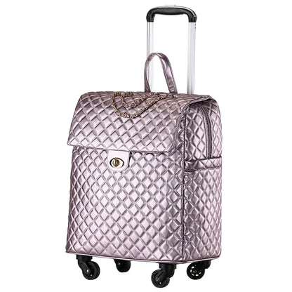 Metallic pink quilted PU leather rolling luggage with a chain detail, turn-lock flap, top handle, and extendable trolley handle.