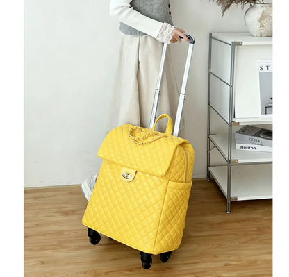 Yellow quilted rolling travel bag with a flap closure, twist lock, top handle, and telescoping handle.