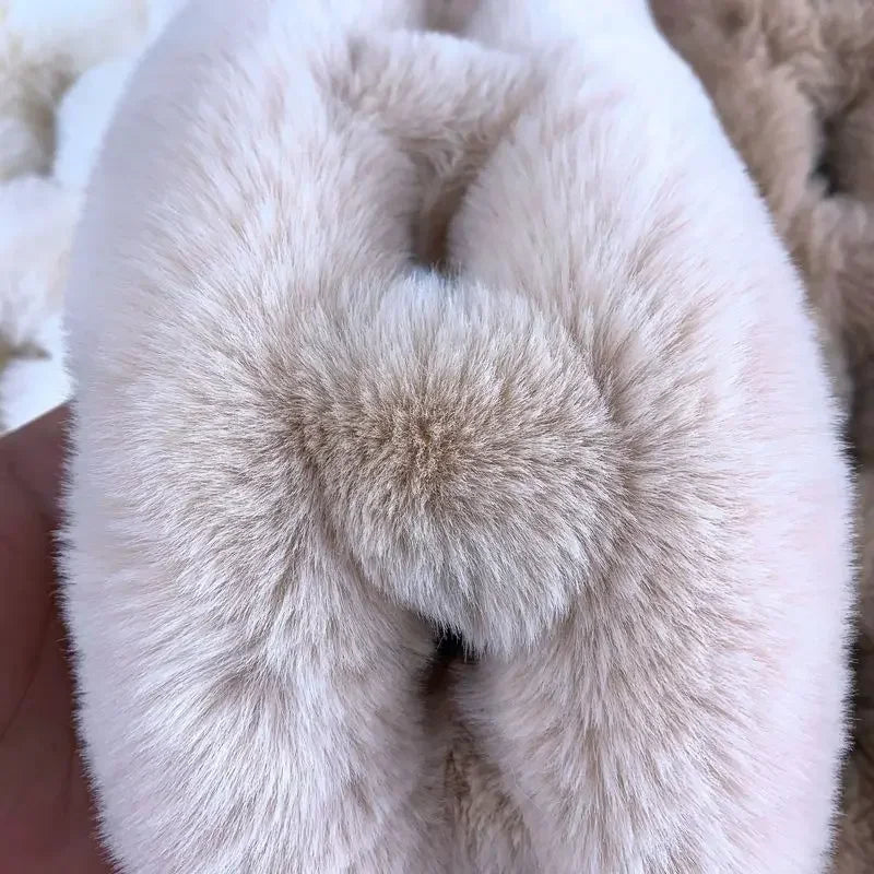 Beige plush faux fur cross scarf with a fluffy pom-pom detail.