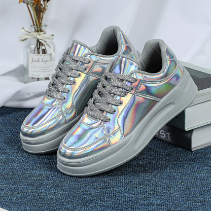 Silver holographic lace-up sneakers with thick grey soles and glittery laces.