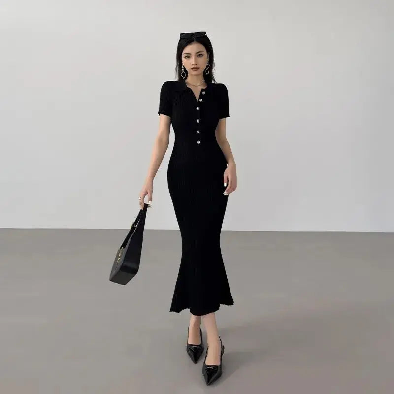 Black ribbed knit mermaid dress with buttons and fitted silhouette for resort wear.