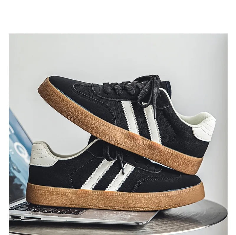 Black canvas sneakers with white stripes, white heel tabs, and gum soles, these breathable shoes are for training.
