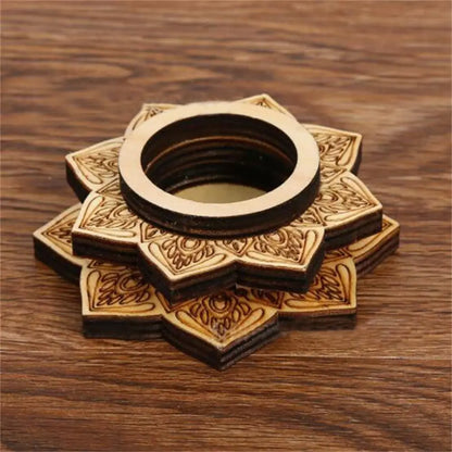 Brown carved wood lotus-patterned crystal ball stand with a round top ring on a wooden surface.