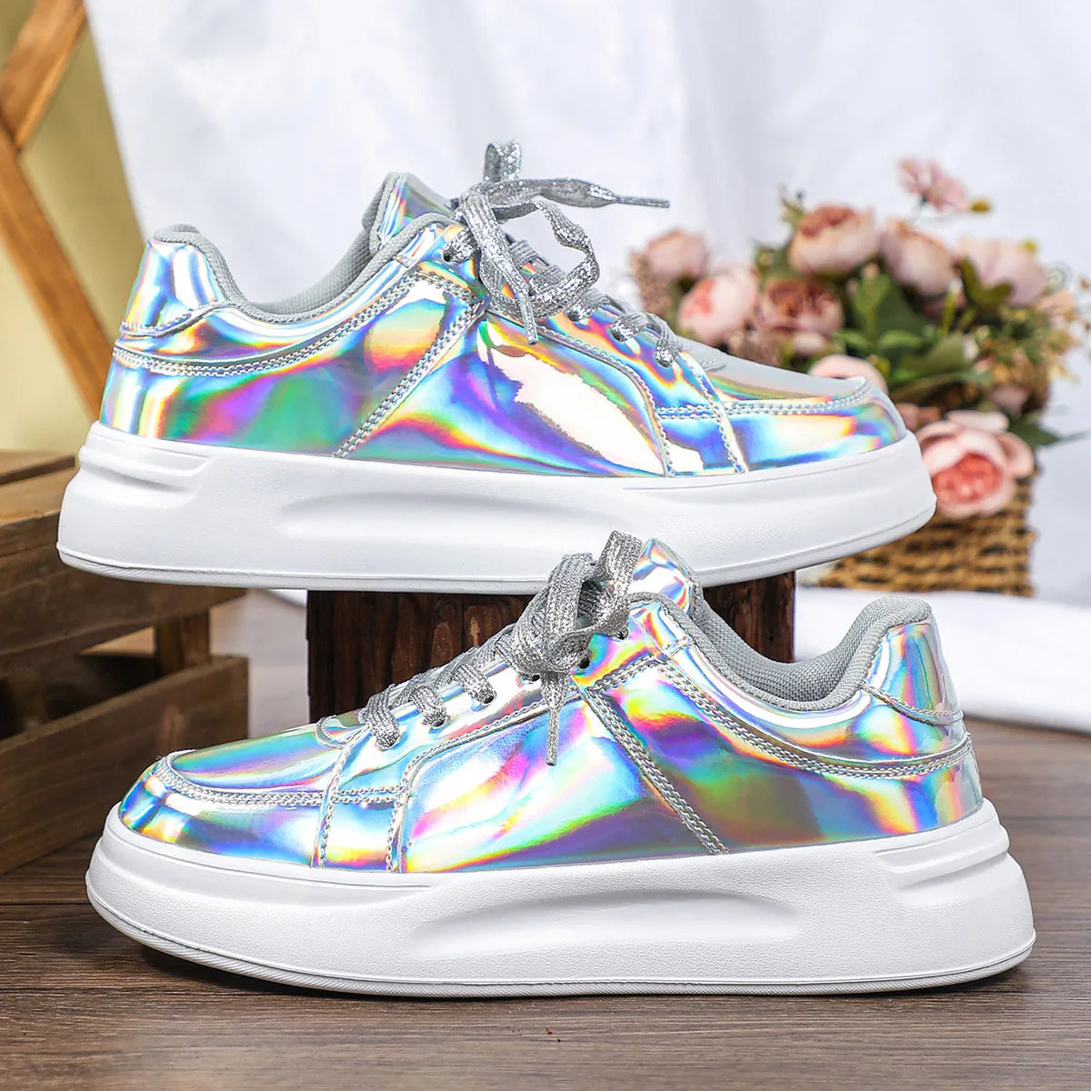 Holographic silver casual sneakers with thick white soles and sparkly silver laces.