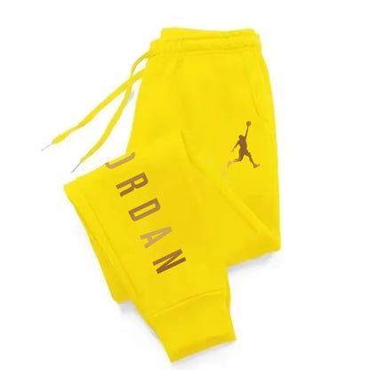 Bright yellow fitted midweight joggers with brown letter print and drawstring waist for athletic wear.