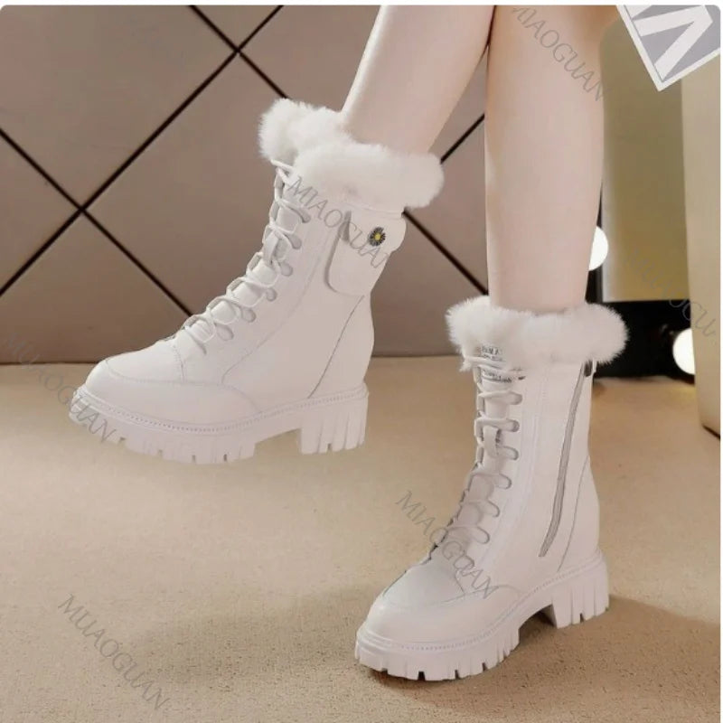 White lace-up snow boots with fur trim, chunky platform heels, and side zippers.