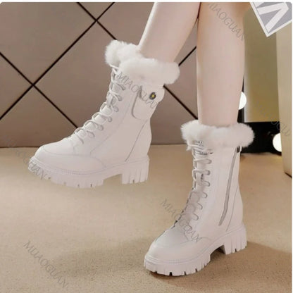 White lace-up snow boots with fur trim, chunky platform heels, and side zippers.