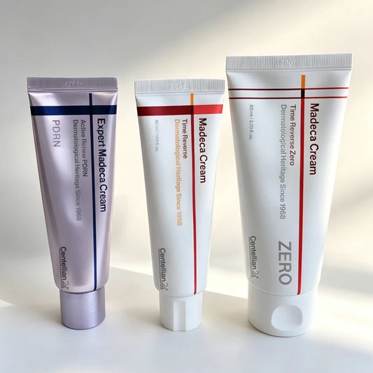 Three skincare tubes of varying sizes in purple and white with text standing upright.