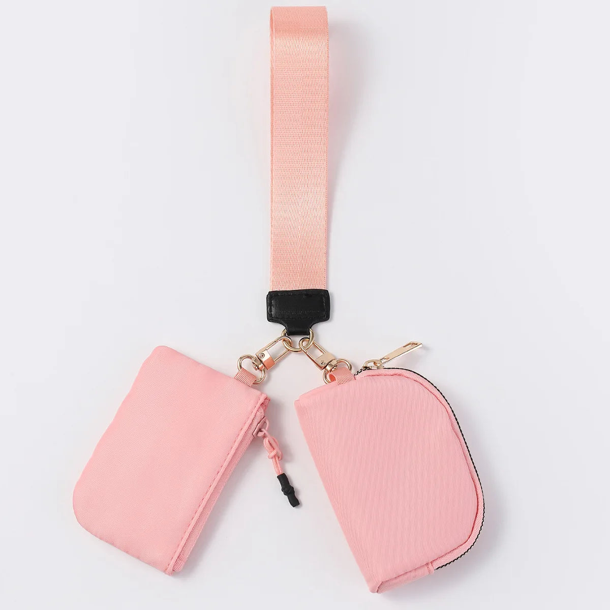 Pink nylon dual pouch wristlet wallet with zip closure for carrying cards, coins, and keys on the go.