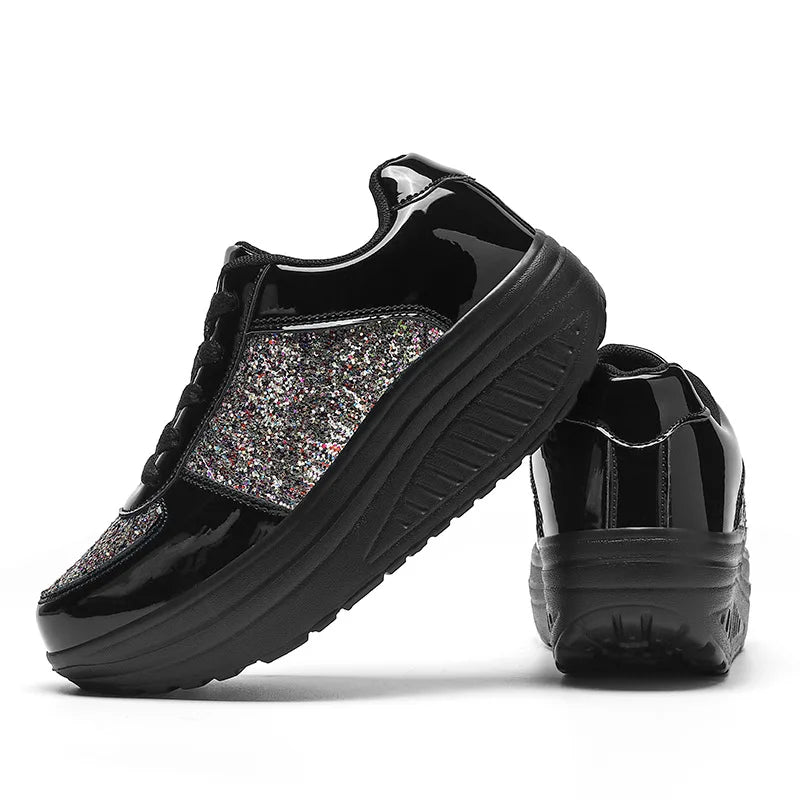 Black patent leather platform wedge sneakers with multi-color sequin panels and lace-up closure.