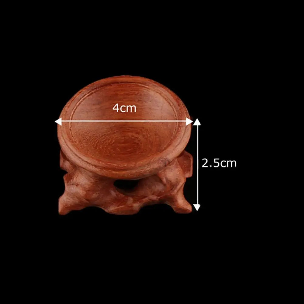 Brown wooden crystal ball stand measuring 4cm wide and 2.5cm tall, featuring an organic rootwood base.