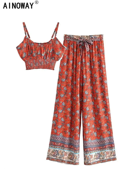 Red floral flowy two-piece set featuring a cropped top and high waist wide leg pants with a drawstring.