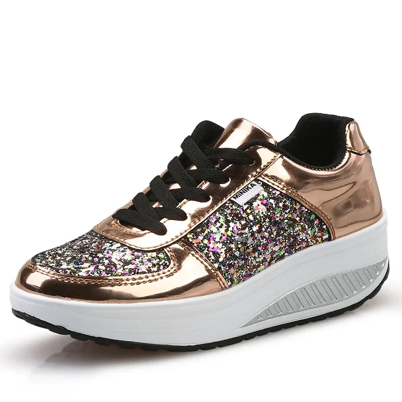 Rose gold metallic and multi-color glitter lace-up sneaker with a chunky white wedge platform sole.