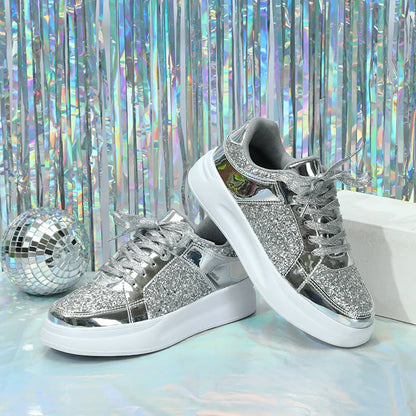 Silver sequin lace-up casual sneakers with metallic panels and thick white soles.
