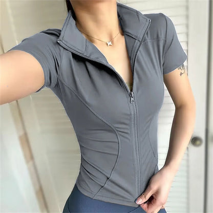 Grey polyester sports jacket with a zip front and fitted design for running, cycling, and yoga.