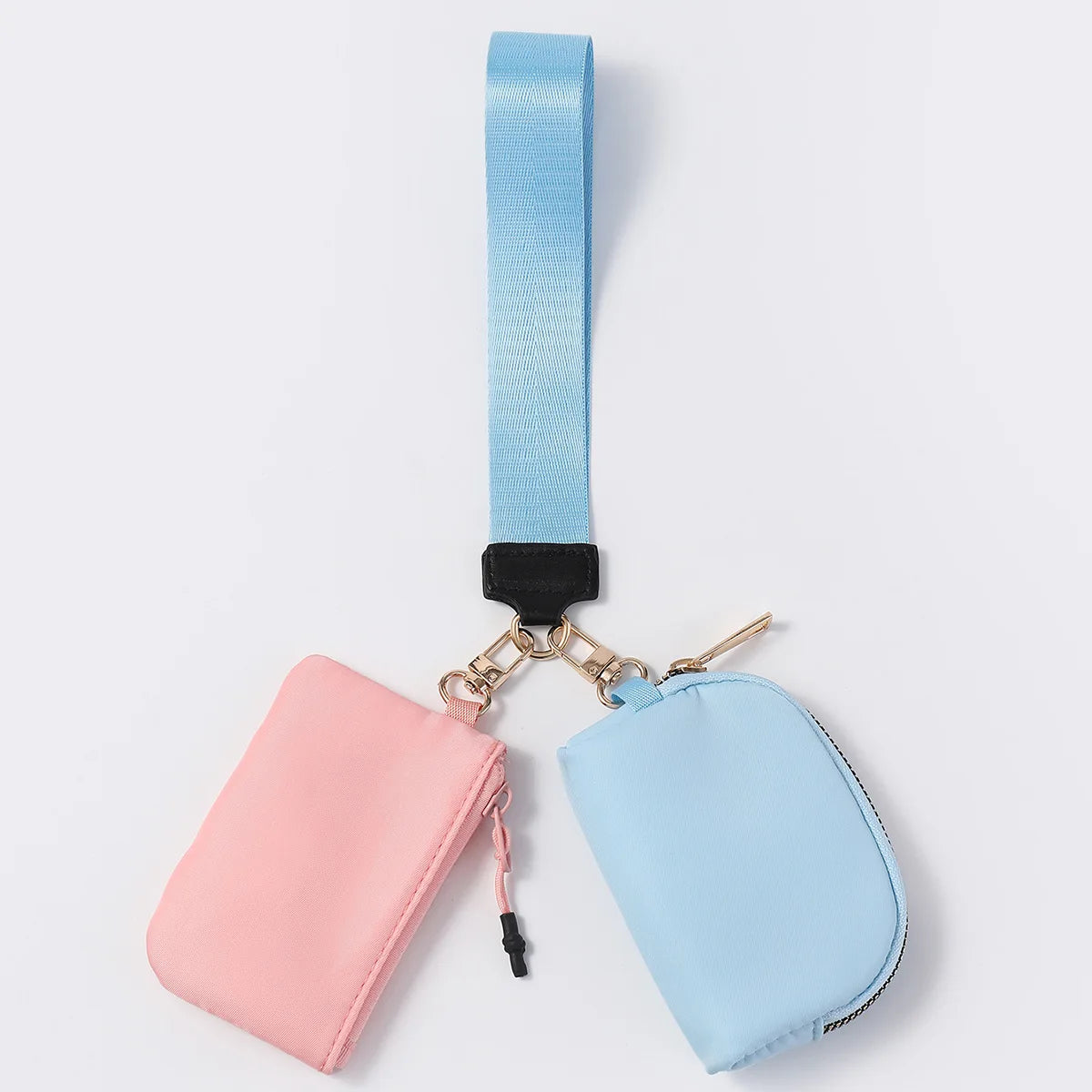 Pink and blue nylon dual pouch wallet with a zip closure and blue adjustable strap for carrying cards on the go.