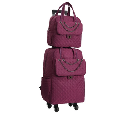 Magenta quilted fabric rolling backpack and matching handbag set with chain accents and top handles.