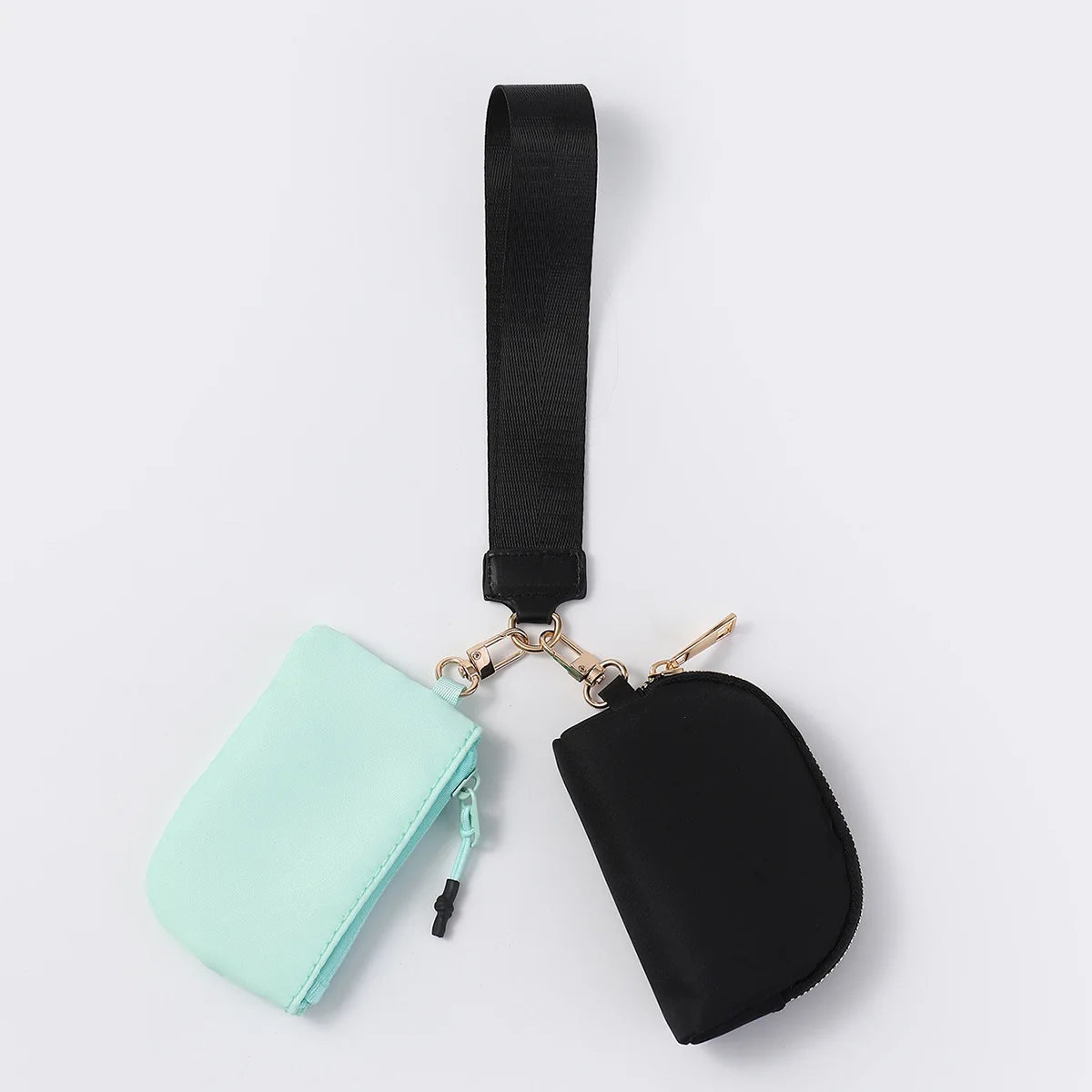 Mint and black nylon zip closure wristlet wallet with two pouches for daily errands.