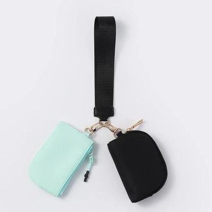 Mint and black nylon zip closure wristlet wallet with two pouches for daily errands.