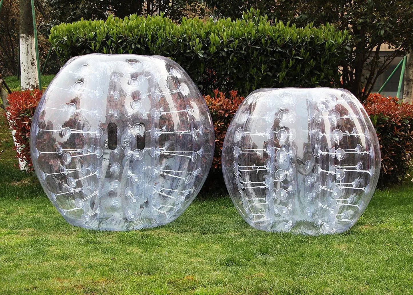 Clear TPU bumper balls with internal tether design for outdoor sports and active play on the grass.