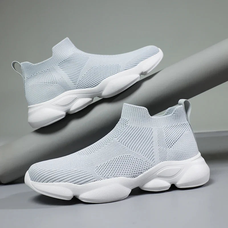 Light grey knit slip-on moccasin sneaker with breathable cotton lining and cushioned white sole for daily wear.