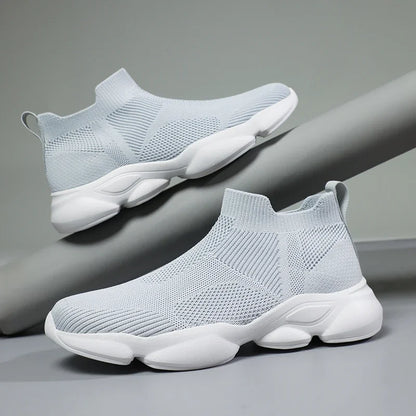Light grey knit slip-on moccasin sneaker with breathable cotton lining and cushioned white sole for daily wear.
