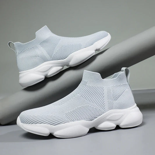 Light grey knit slip-on moccasin sneaker with breathable cotton lining and cushioned white sole for daily wear.