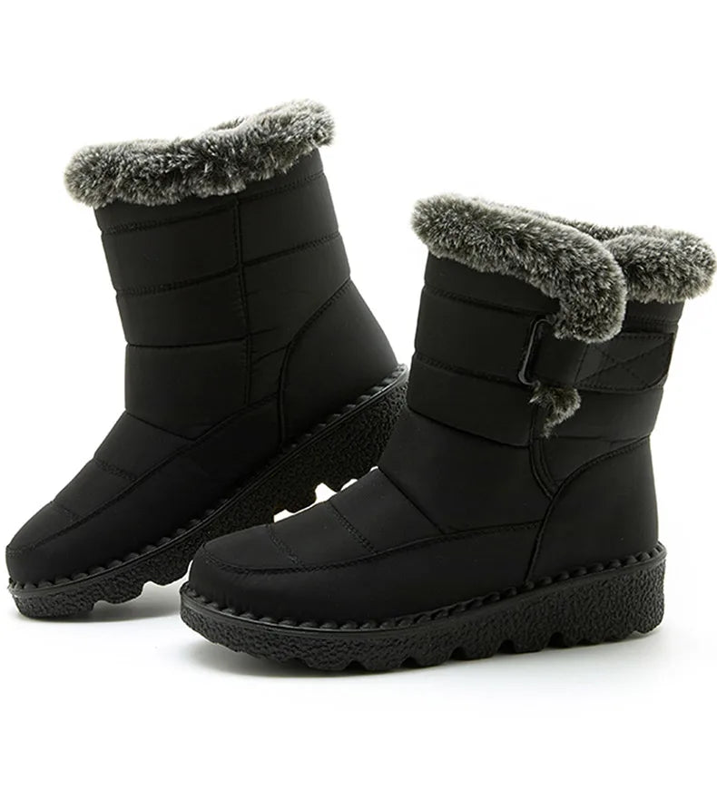 Black quilted winter snow boots with grey faux fur trim and textured flat soles.