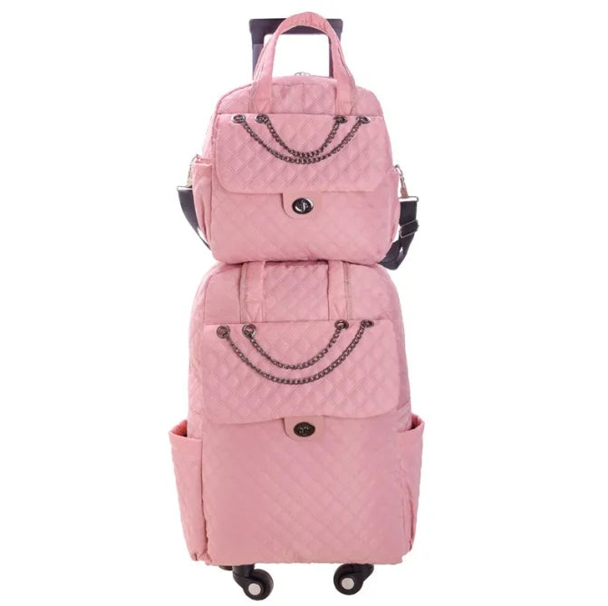 Pink quilted nylon rolling luggage set with chain accents, top handles, front pockets, and a retractable handle.