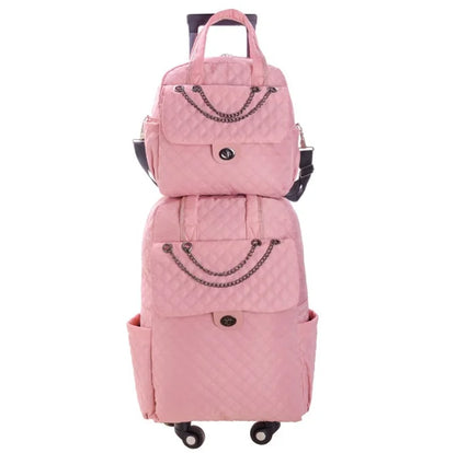 Pink quilted nylon rolling luggage set with chain accents, top handles, front pockets, and a retractable handle.