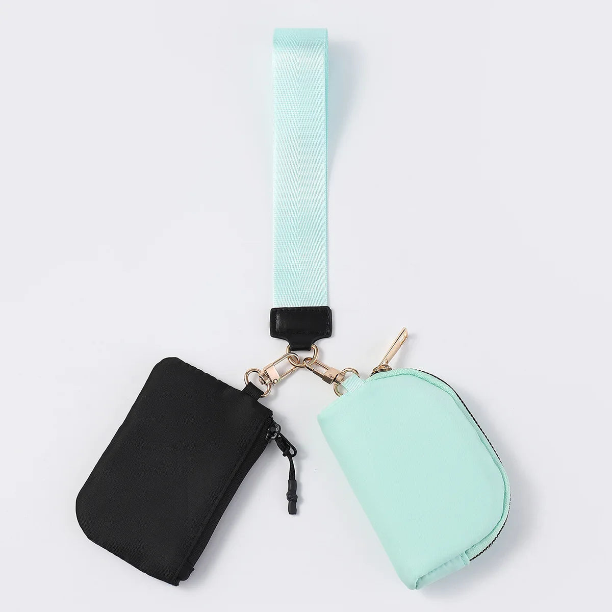 Black and mint nylon dual pouch wristlet wallet with zip closure for holding cards and keys on the go.