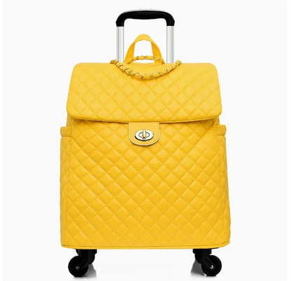 Yellow quilted leather rolling travel suitcase with a gold turn-lock closure, chain detail, and telescoping handle.