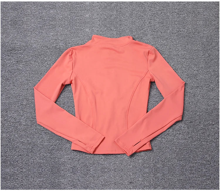 Coral polyester long sleeve fitted sport jacket with thumbholes for yoga training.