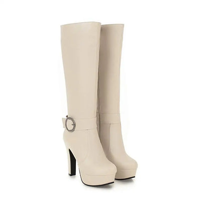 White knee-high platform boots with high heels, side zippers, and ankle buckle straps.