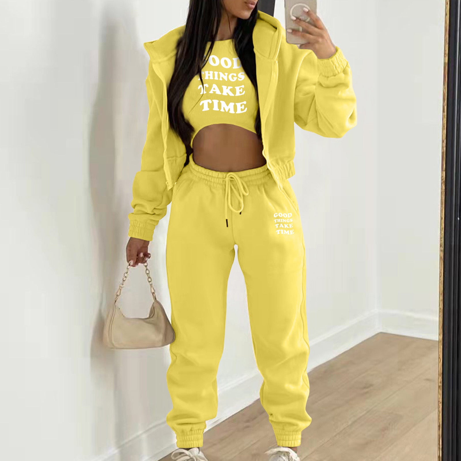 Yellow knit sweater set with white letter print, featuring a hooded jacket and relaxed joggers for loungewear.
