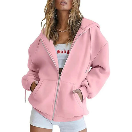 Light pink oversized hoodie with a zip front and pockets for casual wear.