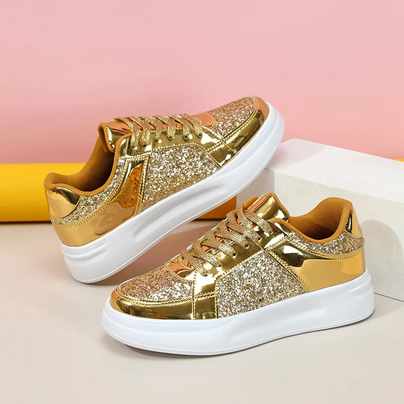 Gold sequin and metallic sneakers with thick white soles and lace-up closure.